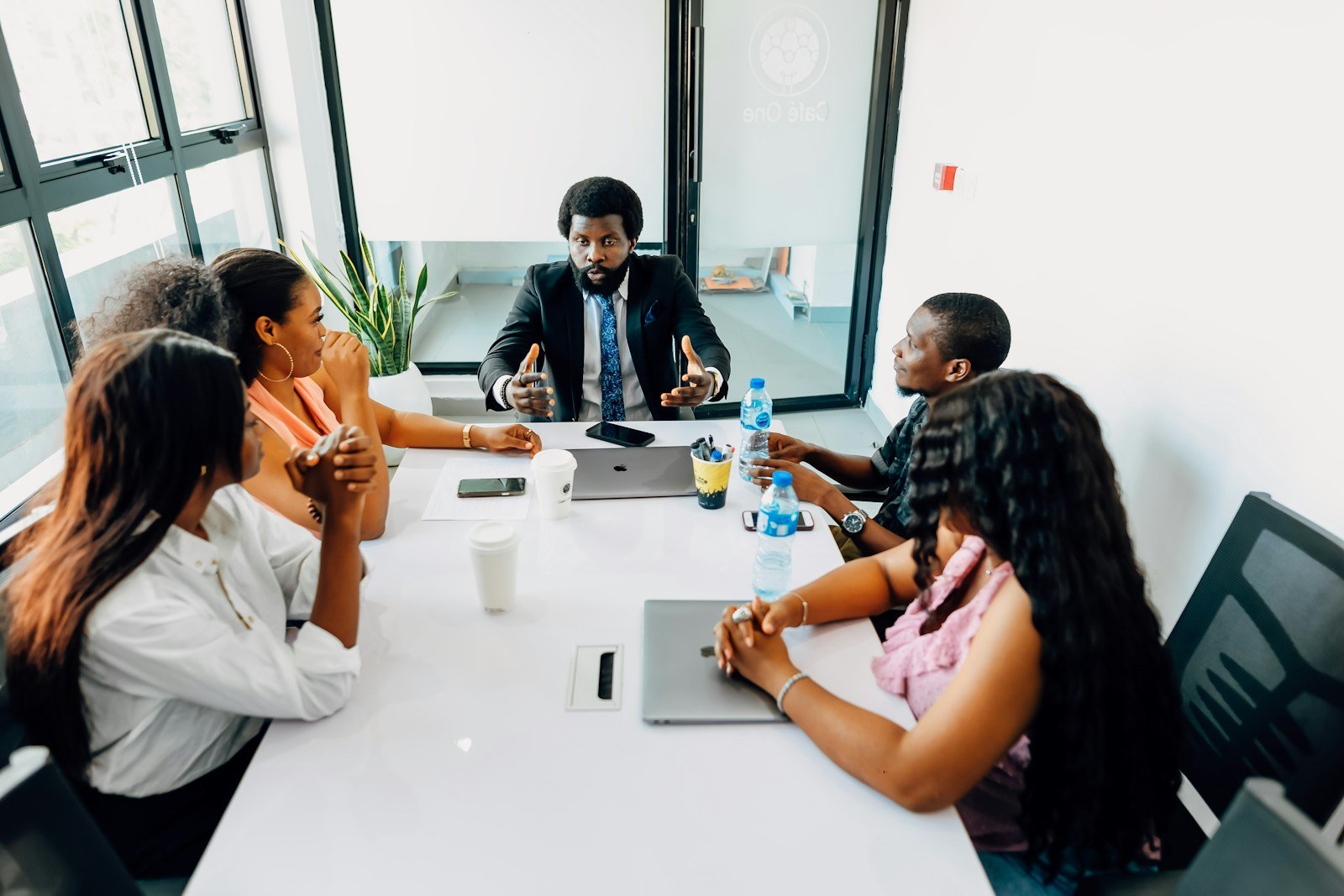 A team meeting around a white table in a Lagos office
